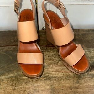 This is a Tory Burch Lexington leather wedge sandal in natural blush. Size 6.